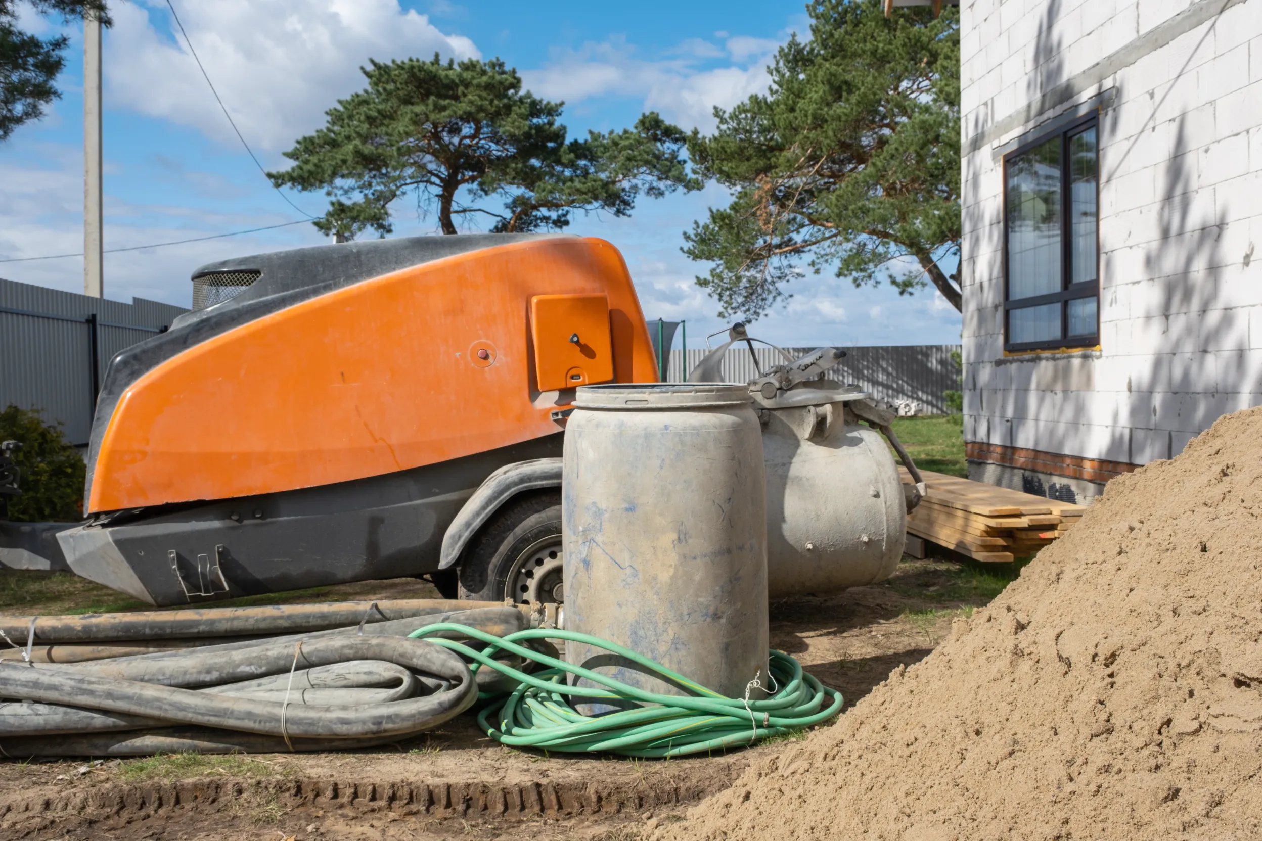Active construction site featuring orange heavy machinery and building structures.